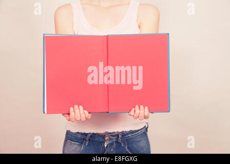 Woman holding book open with blank pages Stock Photo