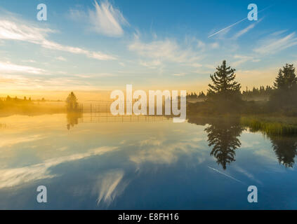 Calm landscape with reflections in river Stock Photo