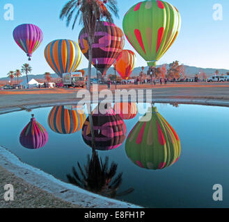 USA, Arizona, Mohave County, Lake Havasu City, Beachcomber Boulevard, Lake Havasu, Lake Havasu Balloon Festival, Hot Air Balloons reflected in pond Stock Photo