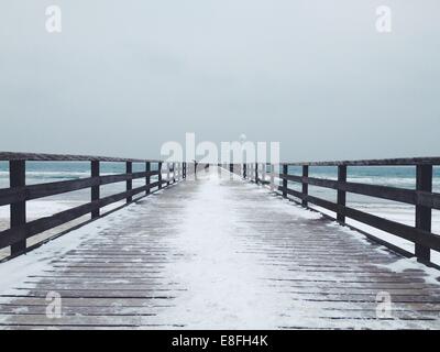Snow covered pier in winter Stock Photo