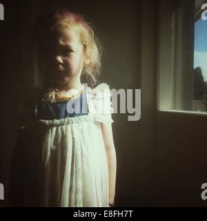 Portrait of a girl standing by a window Stock Photo