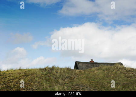 Summer house behind a sand dune, Fanoe, Denmark Stock Photo