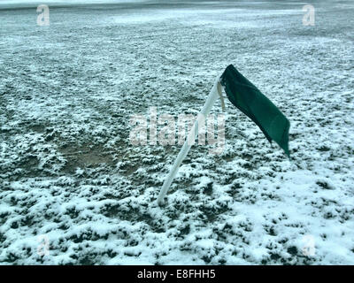 UK, London, London Borough of Haringey, Highgate Village, Football corner flag on snow covered pitch Stock Photo