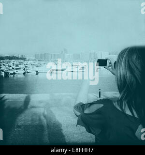 Woman taking a photo, Abu Dhabi, United Arab Emirates Stock Photo
