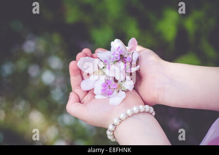 Girl with handful of flowers Stock Photo