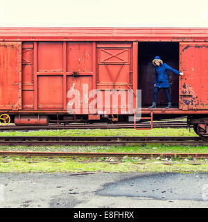 Woman standing in train carriage Stock Photo