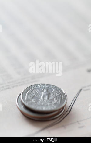 Stack of American quarters on financial graph Stock Photo