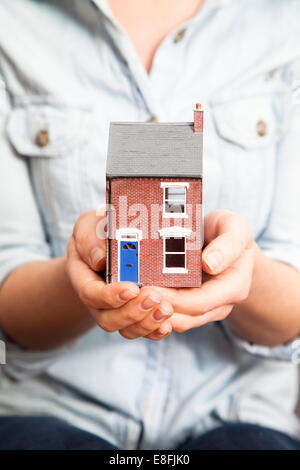 Close-up of a woman holding a model house Stock Photo