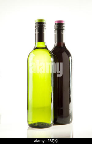 Close-up of a bottle of red wine and a bottle of white wine on a table Stock Photo