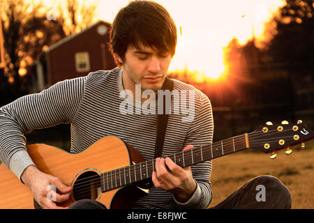 Young man playing guitar Stock Photo