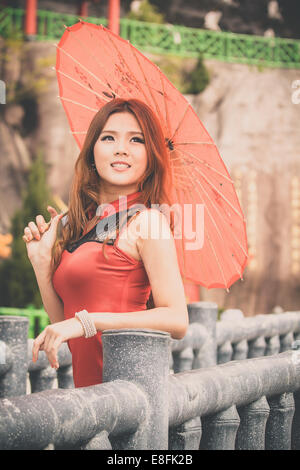 Portrait of young woman with umbrella Stock Photo