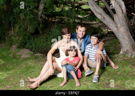Portrait of happy a family sitting in the park, Cape Town, Western Cape, South Africa Stock Photo