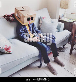 United Kingdom, England, Brighton, Box Head (12-13) watching television Stock Photo