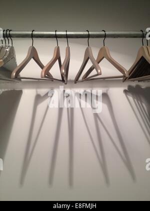 Empty coat hangers in wardrobe Stock Photo