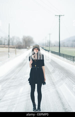 Portrait of a young woman standing on an icy road, Tennessee, USA