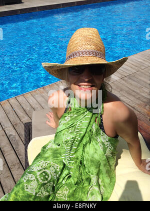 Straw hat on the sun lounger by the pool. Vacation with a tourist Stock  Photo - Alamy