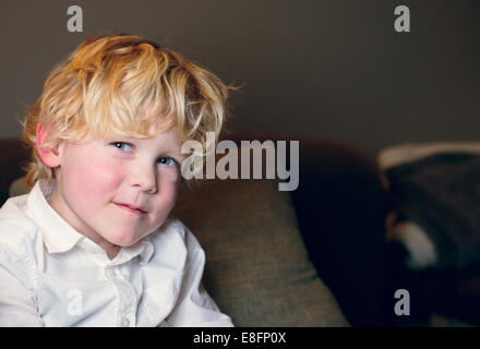 Netherlands, Blonde boy (4-5) in white shirt smiling Stock Photo
