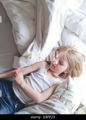 Overhead view of boy sleeping in bed Stock Photo