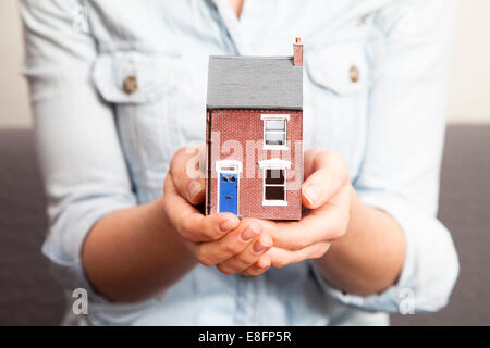 Close-up of a woman holding a model house Stock Photo
