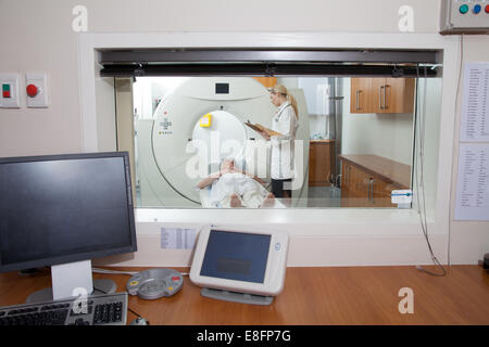 Doctor talking to male patient in hospital scanning room Stock Photo
