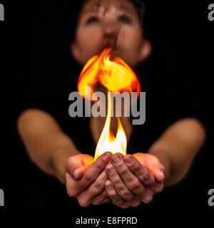 Woman holding fire in her hand Stock Photo