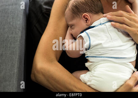 Mother holding newborn baby boy Stock Photo