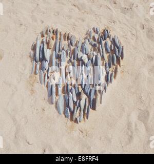 Heart in the sand made with pebbles Stock Photo