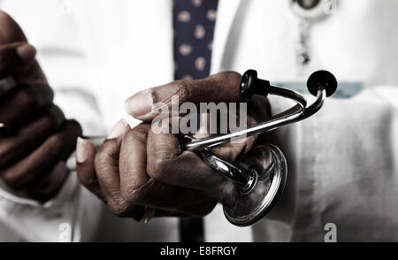 Doctor holding stethoscope Stock Photo
