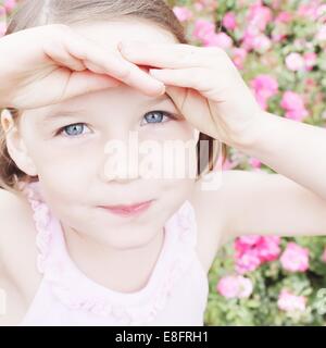 Portrait of a girl shielding her eyes Stock Photo