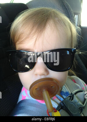 Portrait of girl (18-23 months) with dummy and sunglasses Stock Photo