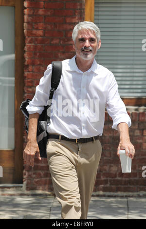 Businessman walking down street with coffee Stock Photo