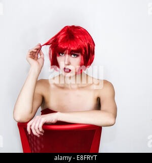 Woman in red wig Stock Photo