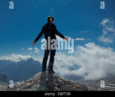 Man standing on the top of a mountain Stock Photo