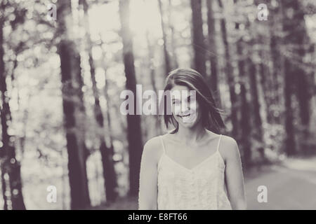 Woman walking down road during springtime Stock Photo