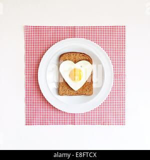 Heart shaped egg on slice of toast Stock Photo