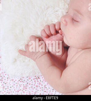 Baby girl lying on side sleeping Stock Photo