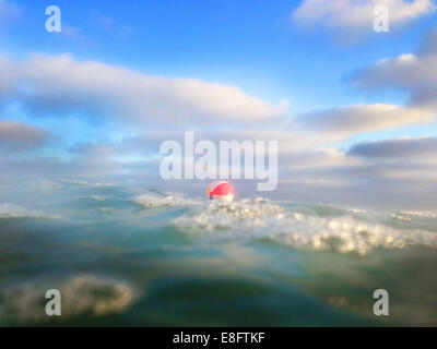 Beach ball floating in ocean, Orange County, California, United States Stock Photo