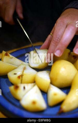 Woman's hand cutting pears Stock Photo