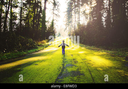 Boy standing in forest (4-5 years) Stock Photo