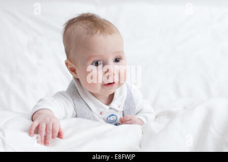 Portrait of a baby boy in bed Stock Photo