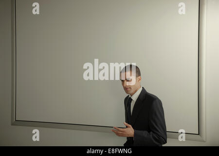 Businessman in office conference room giving presentation Stock Photo