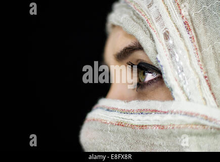 Portrait of a woman with her face covered Stock Photo