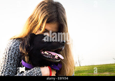 Argentina, Buenos Aires, View of teenage girl (14-15 years) hugging dog Stock Photo