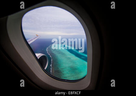 Tropical islands seen from plane window, Maldives Stock Photo