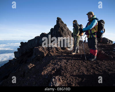 Climbing Mt. Fuji, JAPAN - Japanese Hikers at the summit at dawn Stock Photo