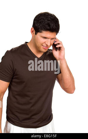 Young man talks on his cellphone against white background. Stock Photo