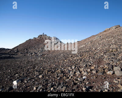 Climbing Mt. Fuji, JAPAN - The peak including the weather station in the background at dawn. Stock Photo