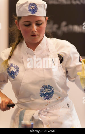 Earls Court, London UK. 7th October 2014. The Restaurant Show Competition Kitchen holds the Young National Chef of the Year, the 4th Craft Guild of Chefs’ competition for chefs aged 18 to 23 with 8 chefs competing live in the final. April Lily Partridge of The Club at The Ivy in London preparing the menu. Credit:  Malcolm Park editorial/Alamy Live News. Stock Photo