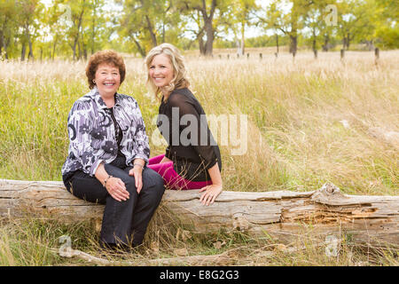 Lovely family enjoying weekend in open space park in early Autumn. Stock Photo