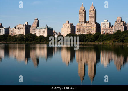 Skyline of Central Park West seen from the Lake in Central Park New York City. The Central Park Lake, in conjunction with the Ra Stock Photo